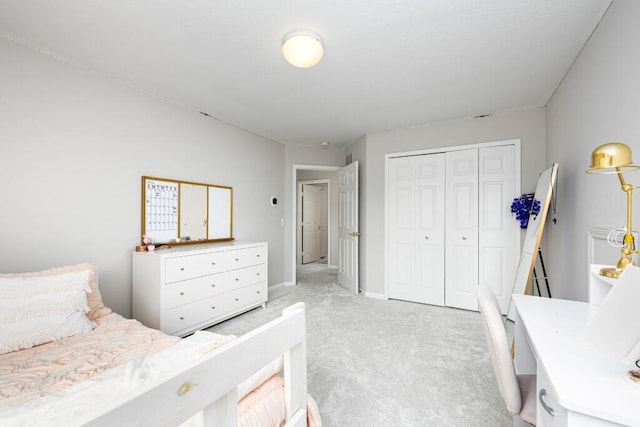 bedroom featuring baseboards, light carpet, and a closet