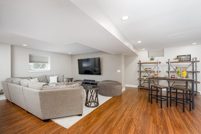 living area featuring recessed lighting, baseboards, and wood finished floors