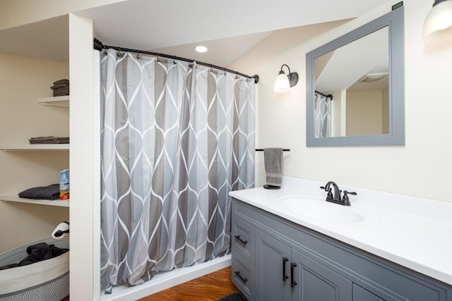full bathroom featuring vanity, a shower with curtain, recessed lighting, and wood finished floors