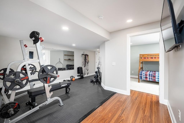 exercise area featuring recessed lighting, baseboards, and wood finished floors