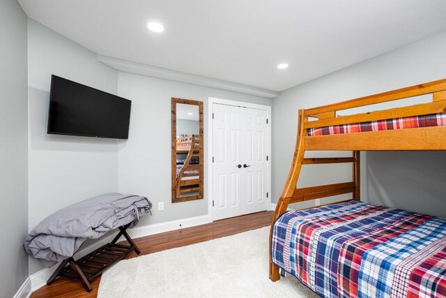 bedroom featuring baseboards, recessed lighting, and wood finished floors