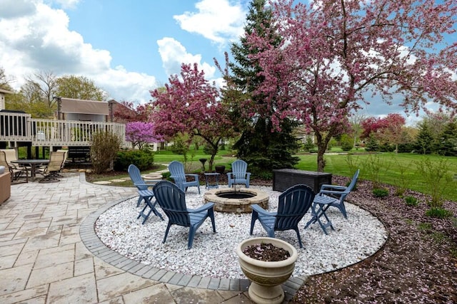view of patio / terrace with an outdoor fire pit and a deck