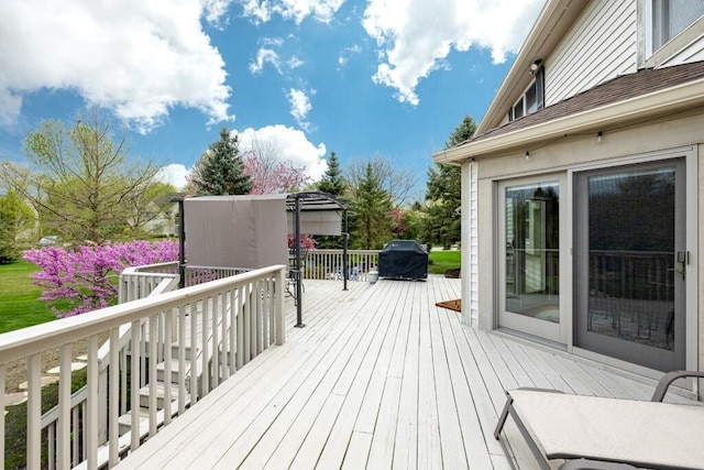 wooden terrace with a grill