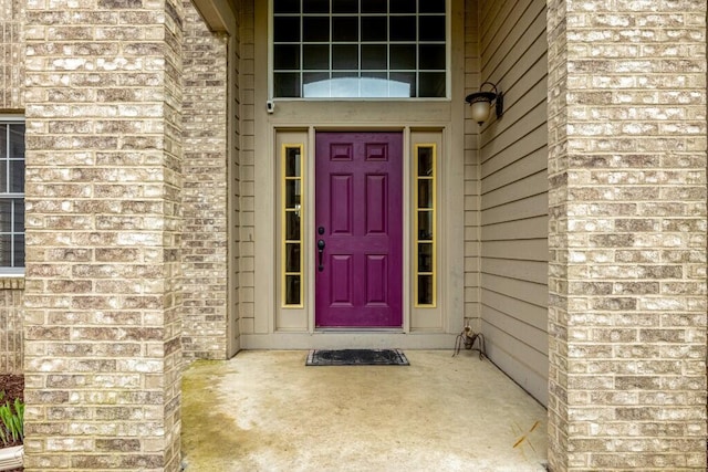 entrance to property with brick siding