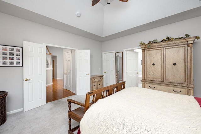 bedroom with carpet floors, high vaulted ceiling, ceiling fan, and baseboards