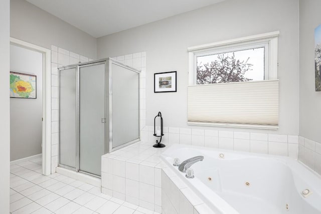 bathroom with a tub with jets, a shower stall, and tile patterned flooring