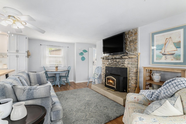 23848 Brady St, Edwardsburg, MI 49112 - living room featuring baseboards, ceiling fan, wood finished floors, and a fireplace