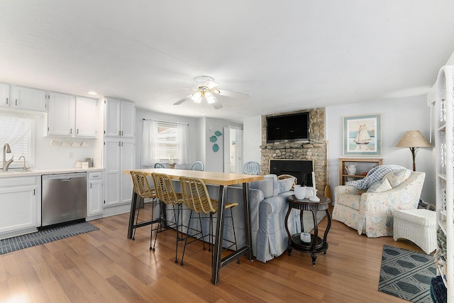 23848 Brady St, Edwardsburg, MI 49112 - living area featuring a ceiling fan, light wood finished floors, and a fireplace