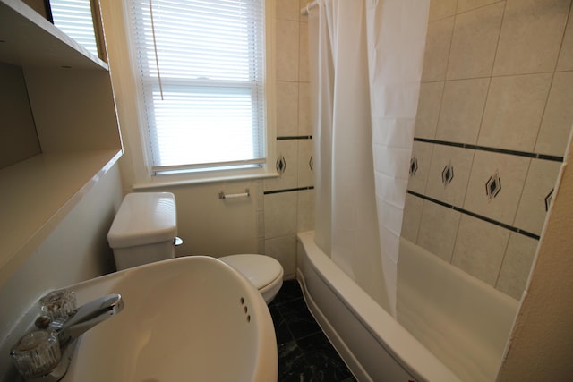 bathroom featuring a sink, marble finish floor, toilet, and shower / tub combo with curtain
