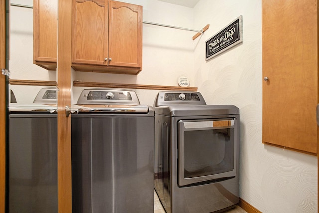 washroom featuring cabinet space and washer and dryer
