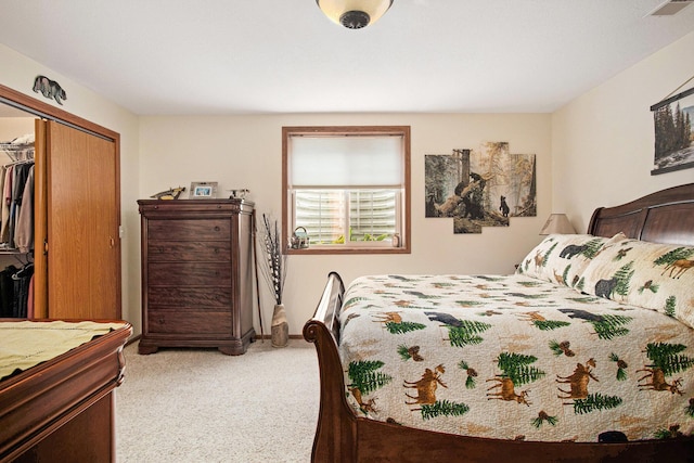 carpeted bedroom featuring a closet and visible vents