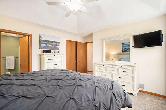 bedroom with visible vents, light carpet, baseboards, ceiling fan, and connected bathroom