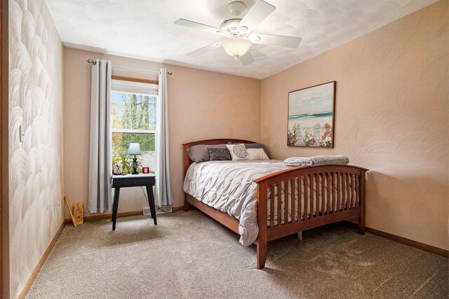 bedroom featuring carpet floors, baseboards, and a ceiling fan
