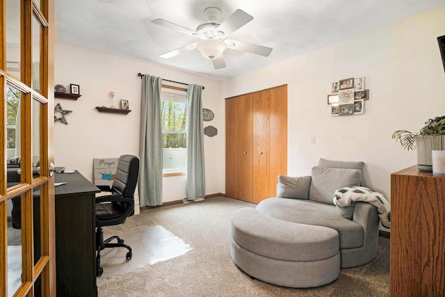 office area with carpet floors, a ceiling fan, and baseboards