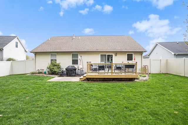rear view of house with a patio, a fenced backyard, a wooden deck, and a yard