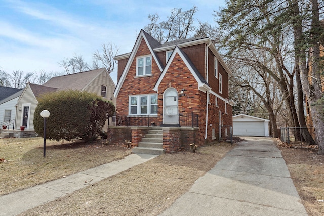 17193 Pierson St, Detroit, MI 48219 - tudor-style house featuring a detached garage, an outbuilding, and brick siding