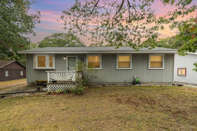 ranch-style home with a yard