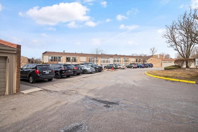 uncovered parking lot with a residential view