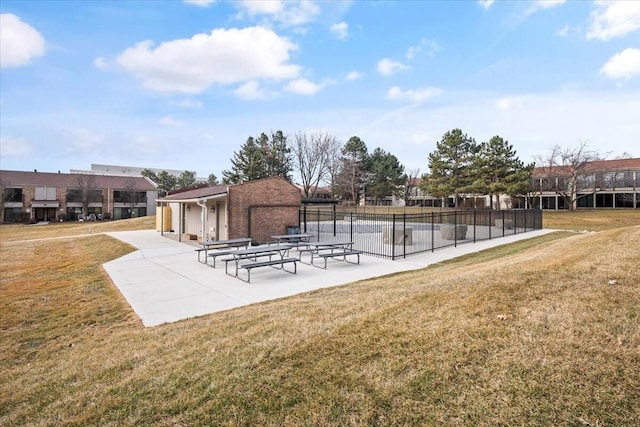 surrounding community featuring fence, a patio, and a yard