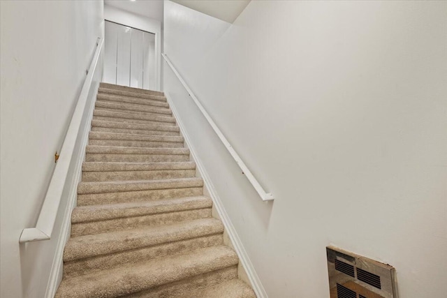 staircase with heating unit and carpet floors
