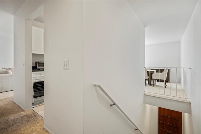 staircase featuring carpet flooring, heating unit, and a toaster