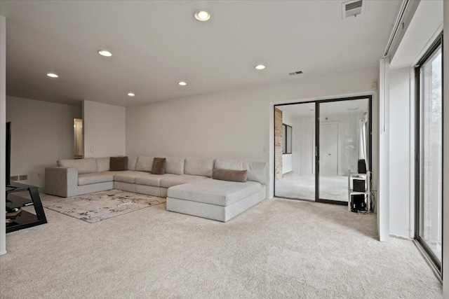 carpeted living room featuring recessed lighting and visible vents