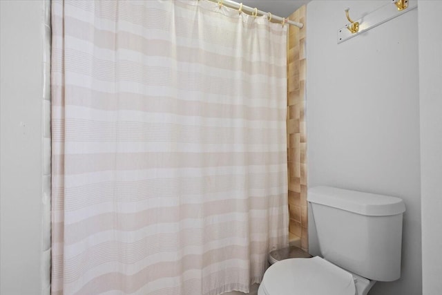 full bathroom with toilet and curtained shower