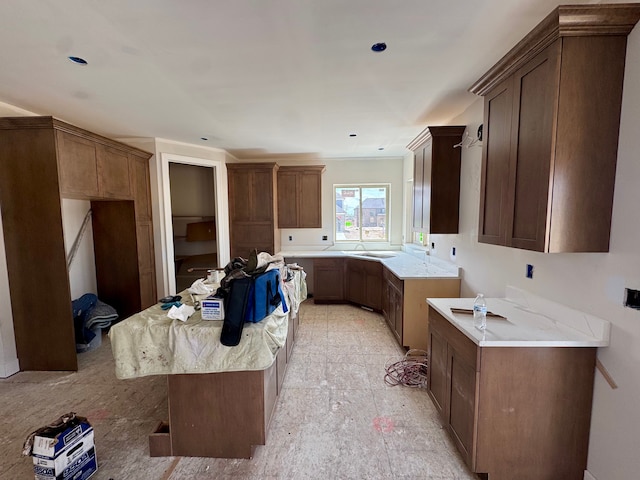 kitchen with light stone counters and a kitchen island