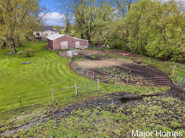 view of yard featuring a garage, fence, an outbuilding, and an exterior structure