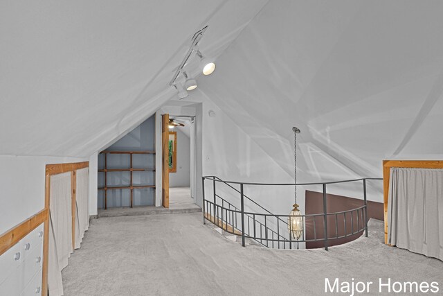 additional living space featuring carpet floors, a ceiling fan, and lofted ceiling