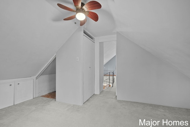 additional living space with carpet floors, ceiling fan, and vaulted ceiling