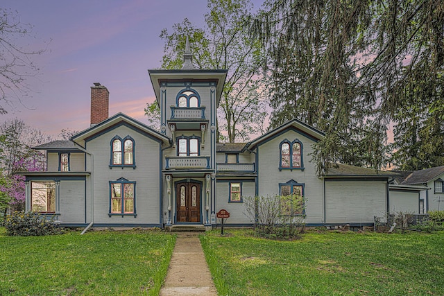 italianate home with french doors and a front lawn