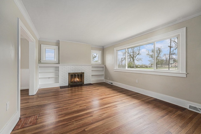 unfurnished living room with plenty of natural light, ornamental molding, and wood finished floors