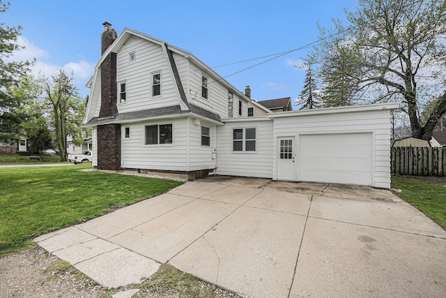 view of side of property with driveway, a chimney, a lawn, a gambrel roof, and an attached garage