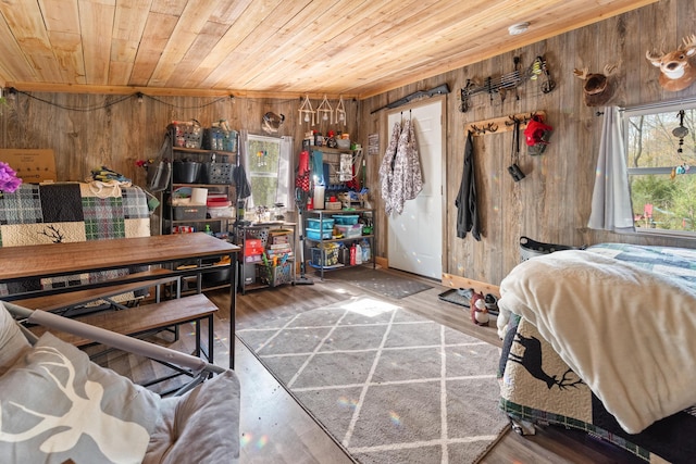 bedroom featuring wood ceiling, wood finished floors, and wooden walls