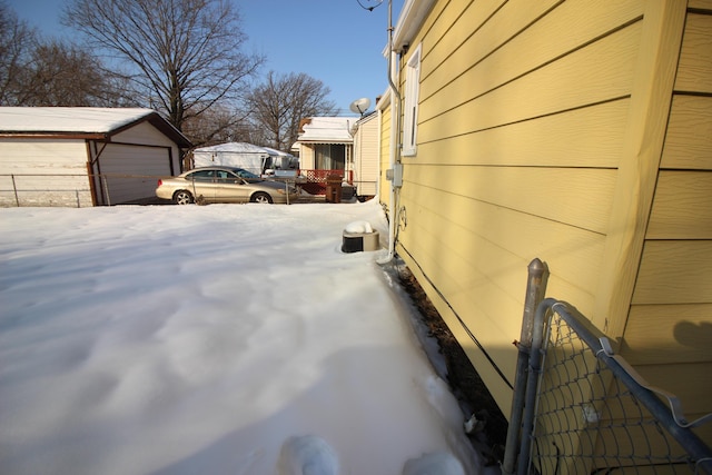 view of snowy exterior featuring an outdoor structure