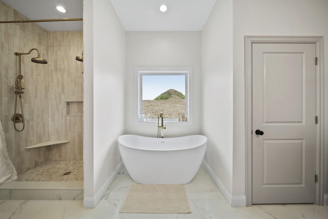 full bathroom featuring a freestanding bath, a tile shower, baseboards, marble finish floor, and recessed lighting
