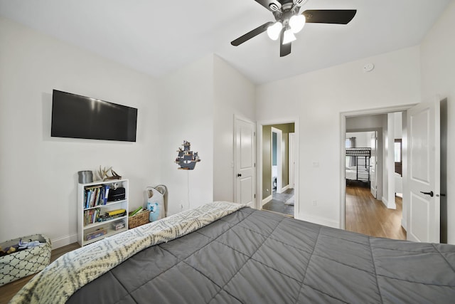 bedroom featuring baseboards, ceiling fan, and wood finished floors