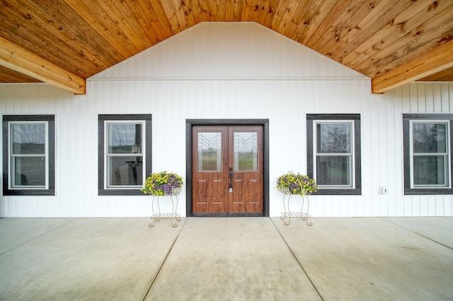 view of exterior entry with french doors and a patio area