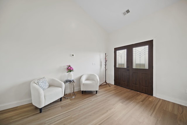 foyer entrance with baseboards, visible vents, and light wood-type flooring