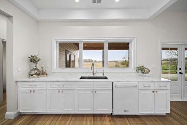 kitchen featuring a sink, white cabinetry, dishwasher, and light stone countertops
