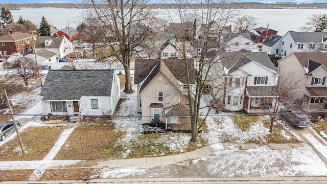 snowy aerial view featuring a residential view