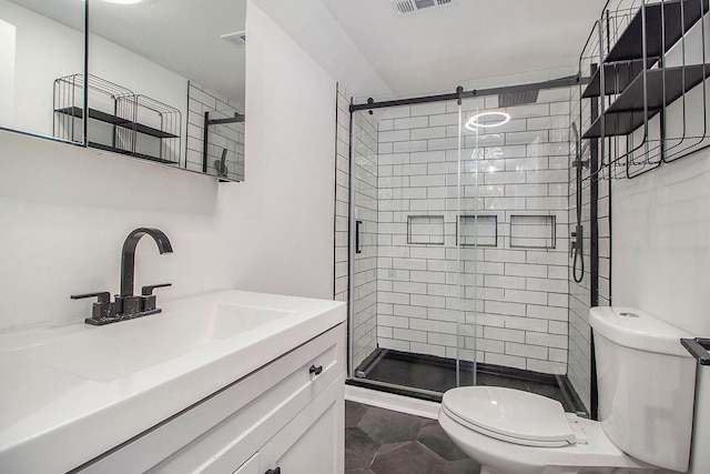 full bathroom featuring vanity, visible vents, toilet, and a shower stall