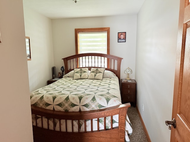 bedroom with baseboards and carpet flooring