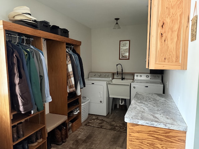 clothes washing area featuring separate washer and dryer, a sink, cabinet space, and dark wood finished floors