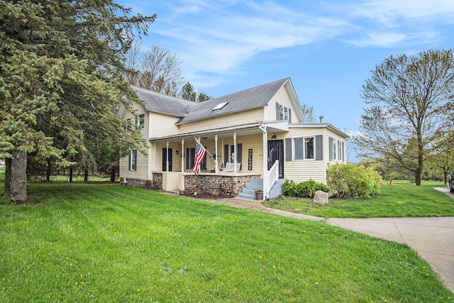view of front facade with roof with shingles, stone siding, a porch, and a front yard