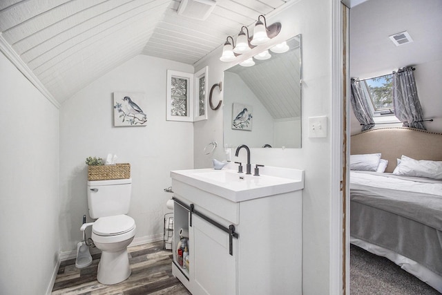 bathroom featuring visible vents, vaulted ceiling, wood finished floors, toilet, and connected bathroom