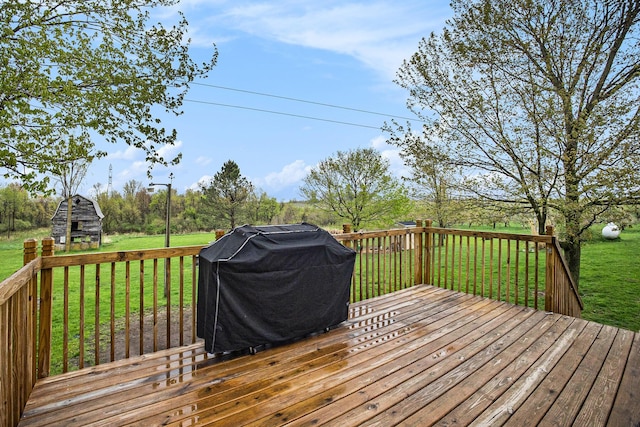 deck featuring a lawn and a grill