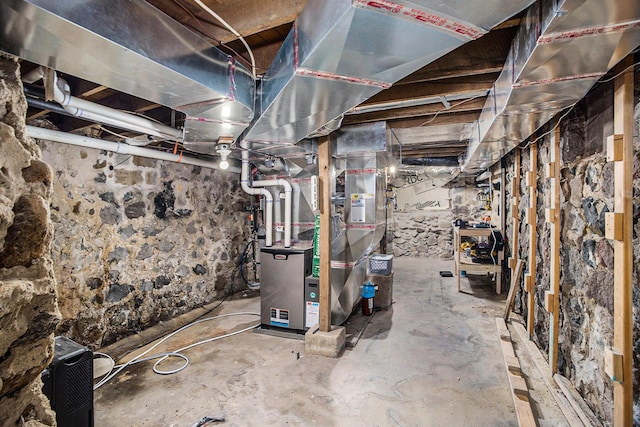 unfinished below grade area featuring heating unit