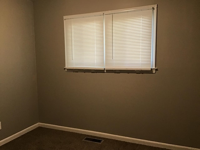 23822 Wellington Ave, Warren, MI 48089 - empty room featuring baseboards, visible vents, and dark colored carpet